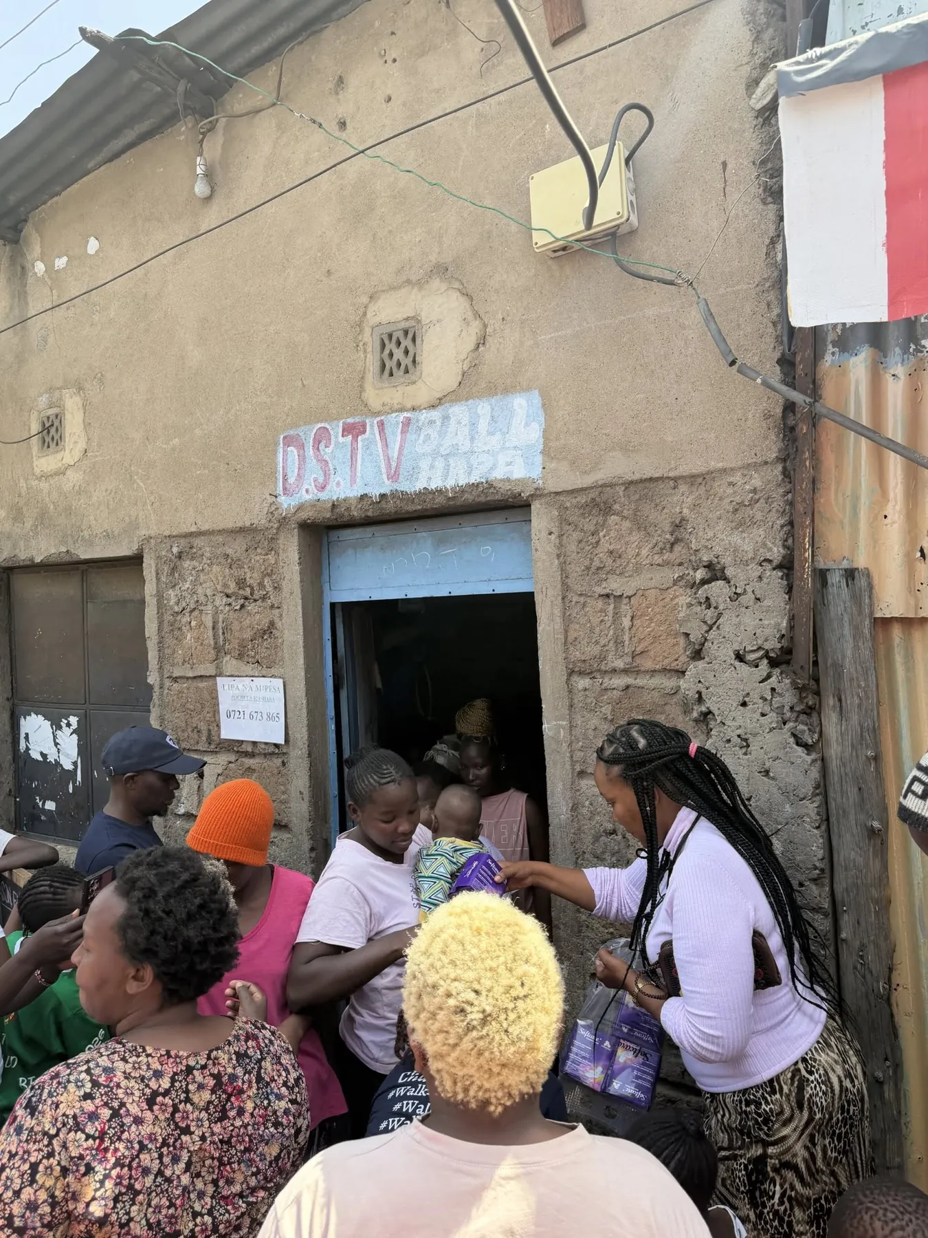 Cecilia Rodgers sharing menstrual-care supplies with women during a community visit