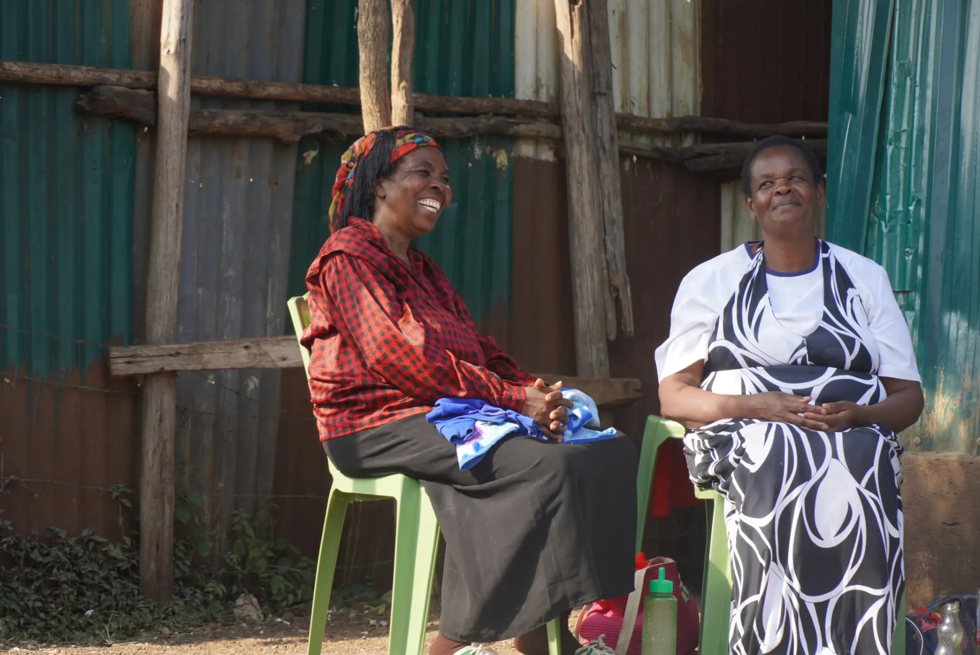 Two women smiling together during an OETWA community conversation